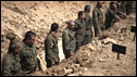  Georgian soldiers stand in a mass grave dug for unknown Georgian troops killed during the conflict