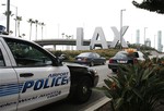 Airport police monitor the entrance of Los Angeles International Airport in Los Angeles, Saturday, Dec. 26, 2009.