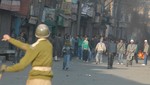 Kashmiri Shiite Muslims throw stone towards indian police  during a Muharram procession in Srinagar December 26, 2009. At least 60 mourners were injured on Saturday when police fired in the air and used teargas shells to break up a procession by hundreds of Shi'ite Muslims in Indian Kashmir's main city, officials said. Public gatherings, including religious processions as well as marches by separatists, have not been allowed in Kashmir since a bloody rebellion against Indian rule broke out in 1989.