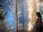 woman watch the Snowman decoration and christmas lights