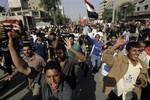 Followers of Shiite cleric Muqtada al-Sadr arrive at Firdous Square in central Baghdad, Iraq for a mass prayer to protest a proposed U.S.-Iraqi security pact on Friday, Nov. 21, 2