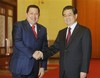 Venezuelan President Hugo Chavez, left, shakes hand with Chinese President Hu Jintao during their meeting at the Great Hall of the People in Beijing, Wednesday, April 8, 2009.