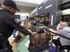 Los Angeles International Airport Officer Jerome Evans works with "K-9 Alda" during increased security checks at Los Angeles International Airport Monday, Dec. 28, 2009.