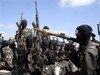 Armed fighters from the Al-shabab group prepare to travel on the back of pickup trucks outside Mogadishu in Somalia on Monday Dec. 8, 2008.