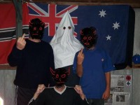 Men pose with KKK hood