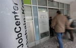 People enter a job center in Berlin, Tuesday, Jan. 5, 2010. The number of unemployed in Germany rose in December by 60,000 amid the global economic downturn, pushing the jobless rate up to 7.8 percent, according to official figures released on Tuesday. The Federal Labor Office said the German unemployment rate grew by 0.2 percentage points from the previous month. A total of 3.276 million people were without jobs in Germany at the end of last year.