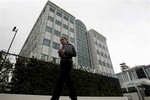 A pedestrian walks past the Greek Stock Exchange in Athens, Thursday, Jan. 14, 2010