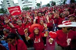 Protestors from the United Front for Democracy Against Dictatorship dance to an early morning rock and roll song near Bangkok, Thailand's Democracy Monument Sunday, March 14, 2010.