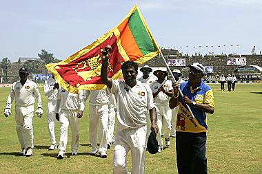 Murali is led off the field following his five-wicket haul