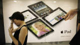 A woman waits in line to buy an Apple iPad at an Apple reseller retail shop during the launch of the devise in Hong Kong on Friday, July 23, 2010.