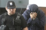 Hiding his face, Israeli citizen Uri Brodsky is escorted by anti-terrorists to a court session in Warsaw, Poland, on Monday July 5, 2010.