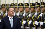 New Zealand's Prime Minister John Key reviews an honor guard with Chinese Premier Wen Jiabao, not seen in the photo, during a welcome ceremony at the Great Hall of the People Beijing, China, Wednesday, April 15, 2009.