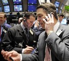 Traders work on the floor of the New York Stock Exchange Monday, Jan. 26, 2009.