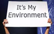 photo of hands holding up a sign saying It's My Environment