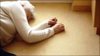 Elderly woman lying on the floor