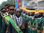 President Robert Mugabe inspects the guard of honour during the official opening of the second session of the seventh parliament of Zimbabwe in Harare, Tuesday, Oct. 6, 2009.