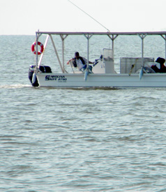 Private contractor in Carolina Skiff with tank of Corexit dispersant, August 10, south of Pass Christian Harbor, 9:30 AM. (Photo: Don Tillman)