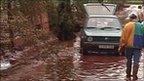 Man and car on road covered in toxic mud