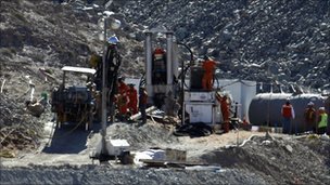 Men work on a drill being used in the rescue operation of 33 trapped miners at the San Jose mine in Copiapo on 30 August 