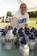 Hospitalman Karrie Cook Branch Medical Clinic, Naval Station Everett, organizes water bottles at the Navy booth prior to the start of the Aqua Sox baseball game.