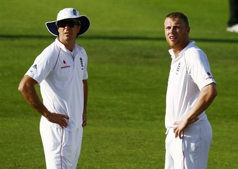 England's Michael Vaughan, left, and Andrew Flintoff await the outcome of the TV replay for the wicket of South Africa's Hashim Amla during the first day of the 2nd test at Headingley cricket ground, Leeds, England Friday July 18, 2008. After a ruling by the third umpire Amla was not out