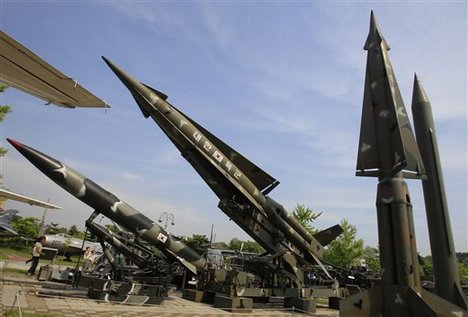 Visitors walk near the mock North Korea's Scud-B missile, right, and other South Korean missiles at Korean War Museum in Seoul, Friday, May 21, 2010. South Korean President Lee Myung-bak said Friday his country was caught in a "perfect military ambush" when a North Korean torpedo sank a naval warship, but called for a cautious response to the disaster that left 46 sailors dead. (AP Photo/Lee Jin-man)