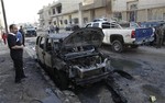 Security forces and people gather at the scene of a bomb attack in Baghdad, Iraq, Wednesday, Nov. 10, 2010. A string of bombings targeted Christian houses in Baghdad early Wednesday, killing and wounding several people, police said.