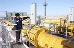 A gas pipeline worker, checks the valves at the gas pumping station at Pisarevka, Russia, seen Tuesday, Jan. 13, 2009. EU Commission President Jose Manuel Barroso has complained directly to Russian Prime Minister Vladimir Putin over the lack of natural gas flowing to Europe, after Russia cut off gas supplies amid a pricing dispute with neighboring Ukraine, and although Russia has restarted gas flows to they accuse Ukraine of blocking the gas from reaching E