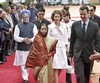 Syrian President Bashar al-Assad, right, Indian President Pratibha Patil, front left, Indian Prime Minister Manmohan Singh, left, and wife of Syrian President Asma Assad, center wearing white, walk together during a ceremonial reception at the Presidential Palace in New Delhi, Wednesday, June 18, 2008. Al-Assad arrived Tuesday on his first visit to India