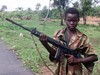 A fourteen year old child soldier for the Sierra Leone Army, Abu Kamara, holds a British self Loading rifle (SLR)