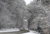 A car drives in the snowy countryside near Chasne sur Illet, western France, Thursday Dec.2, 2010. Nine regions in northwest and southeast France were put on a weather alert, warning of snow and ice until Thursday morning. SNCF, France's national railway, said traffic on the main southeast routes had been affected by heavy snow, but 80 percent of its high-speed trains were still running.