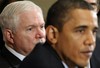 Defense Secretary Robert Gates, left, listens as President Barack Obama speaks during a meeting with members of his Cabinet in the Cabinet Room of the White House in Washington, Monday, Nov. 23, 2009.