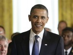 President Barack Obama arrives to meet with the U.S. Naval Academy's 2009 football team as they are honored with the Commander In Chief Trophy in the East Room of the White House in Washington, Monday, May 3, 2010.