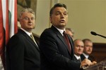 Viktor Orban prime minister candidate of Hungary's center-right wing party Fidesz and winner of the recent parliamentary elections, center, speaks during a press conference announcing his planned government while his deputy prime minister candidate Zsolt Semjen, left, is seen behind him in Budapest, Hungary, Monday, May 3, 2010.