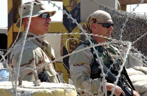 Culinary Specialist 1st Class Dennis Lintz, left, and Boatswains Mate 3rd Class Mark Yarbrough keep watch at an entry control point at the port of Ash-Shu'aibah, Kuwait.