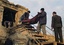 Afghan police men carry a wrapped body of a police officer, who was killed by a suicide attack in Kunduz, north of Kabul, Afghanistan on Thursday, Dec. 23, 2010. Three civilians were also wounded in the blast. The bombing is the second suicide attack in less than a week in Kunduz city.