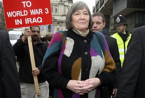 Britain's former International Development Secretary Clare Short, escorted by security, leaves after giving testimony at a hearing of the Iraq Inquiry, at the Queen Elizabeth II Conference Center, London Tuesday Feb. 2, 2010.