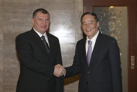 In this photo provided by China's Xinhua News Agency, Chinese Vice Premier Wang Qishan, right, shakes hands with his Russian counterpart Igor Sechin at the Great Hall of the People in Beijing, China, Tuesday, Feb. 17, 2009. Russia and China signed a $25 billion energy deal in Beijing on Tuesday that will see the Asian country secure oil supplies from Moscow for the next 20 years in return for loans, Russia's state pipeline monopoly Transneft