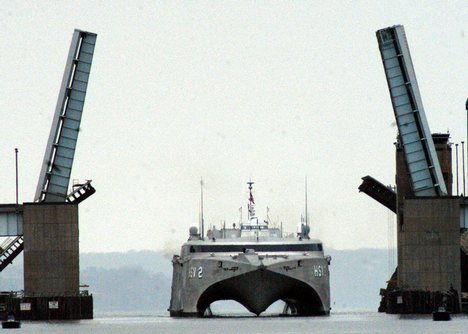 The Woodrow Wilson Bridge lifts opens to let the High Speed Vessel Two (HSV-2) Swift pass as the experimental ship glides across the Potomac River.