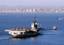 A tugboat tows the decommissioned aircraft carrier Midway into San Diego bay.