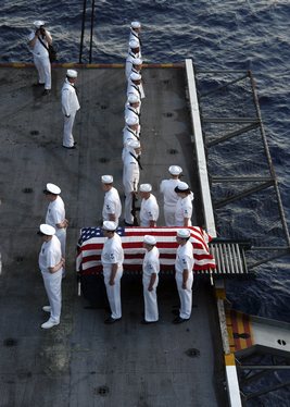 Crew members aboard USS Enterprise (CVN 65) conduct a Burial at Sea for Machinist's Mate 3rd Class Nathan Taylor.