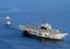 A tugboat tows the decommissioned aircraft carrier Midway into San Diego bay.