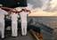 Sailors commit to the sea the body of Machinist's Mate 3rd Class Nathan Taylor during a Burial at Sea.