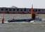 Naval research submarine, NR-1, pulls in to Norfolk Naval Station alongside the U.S. submarine support ship MV Carolyn Chouest. NR-1 is the Navy's smallest and only research submarine.