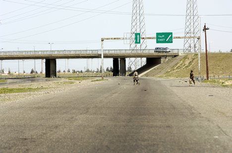 Iraqi soldiers assigned to the 1st Battalion, 1st Brigade, 4th Division investigate potential improvised explosive devices (IEDs), left near Tikrit, Iraq.