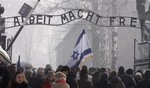 Visitors from around the world passing under the infamous Arbeit Macht Frei "Work Sets You Free" sign over the main gate at the former Nazi death camp of Auschwitz on Wednesday, Jan. 27, 2010 just hours before solemn ceremonies to mark 65 years since the camp was liberated by the Red Army.