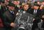 Chancellor Angela Merkel and former Polish President Lech Walesa hold a black and white picture showing cars and people at the border crossing after the Fall of the Berlin Wall 1989, in Berlin, Germany, Monday, Nov. 9, 2009, during the commemorations of the 20th anniversary of the fall of the Berlin Wall on Nov.9, 1989.