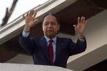 Former dictator Jean-Claude "Baby Doc" Duvalier waves to supporters from the balcony of a rented guest house where he is staying in Port-au-Prince, Haiti, Friday Jan. 21, 2011.