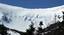 Bowl of Tuckerman Ravine, showing skiers above the lip. The mountain is part of a popular hiking area, with the Appalachian Trail crossing the summit and one of the Appalachian Mountain Club's eight mountain huts, the Lakes of the Clouds Hut, located on one of the mountain's shoulders