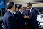 President Barack Obama talks with Chinese President Hu Jintao during the morning plenary session of the G-20 Pittsburgh Summit at the David L. Lawrence Convention Center in Pittsburgh, Penn., Sept. 25, 2009.